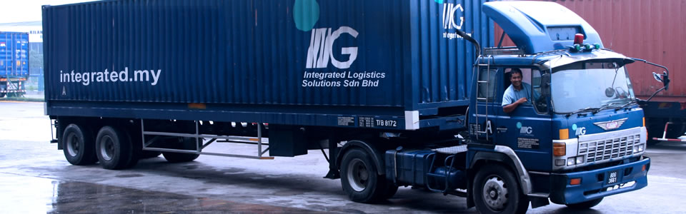 An ILS 40-foot box trailer printed with integrated.my, driver at the wheel
