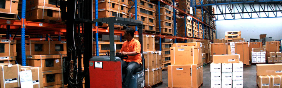 An ILS reach truck working a high-bay racking aisle stacked with palletised cartons