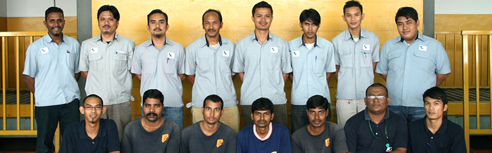 Around twenty ILS warehouse staff in uniform, photographed inside the warehouse
